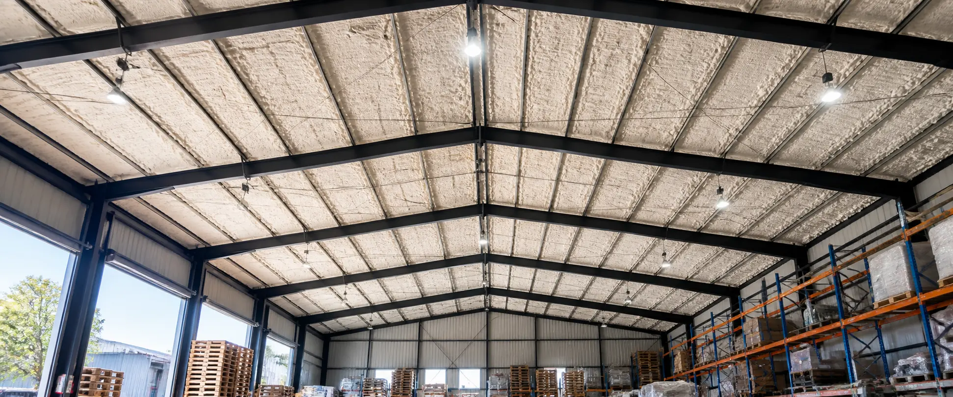 spray foam insulation applied to warehouse metal roof structure